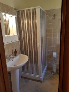 a bathroom with a sink and a shower stall at B&B Sant'Angelo in Licata