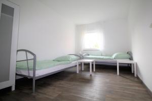 Ένα ή περισσότερα κρεβάτια σε δωμάτιο στο Work & Stay Sankt Augustin