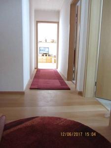 an empty hallway with a hallway leading to a room at Haus Harmonie in Bad Driburg