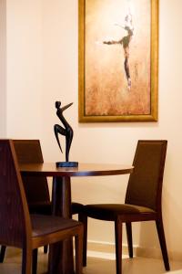 a table with a statue of a woman on it at Melon Suites in Thessaloniki