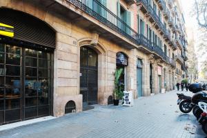a building with a motorcycle parked next to a street at Brummell Apartments Eixample Derecha/Ballroom in Barcelona