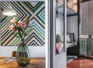 a vase filled with pink flowers sitting on a table at Brummell Apartments Eixample Derecha/Ballroom in Barcelona