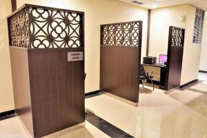a lobby with a wooden door and a desk at Best Western Plus Salmiya in Kuwait