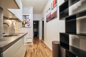 a kitchen with a sink and a counter at LEGENDARY RUE DU TEMPLE 4/5 bedrooms in Paris