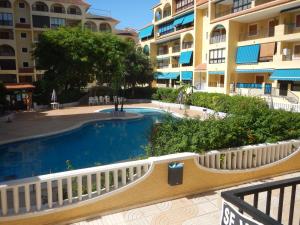 a swimming pool in front of a building at Daria in La Mata