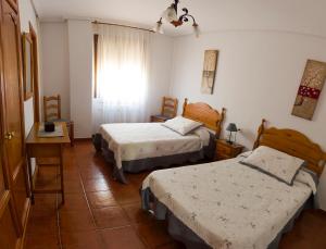 A bed or beds in a room at Apartamentos Rurales El Prado