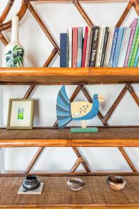 a wooden shelf with books and a blue bird on it at Villa Thea in Panormos Skopelos