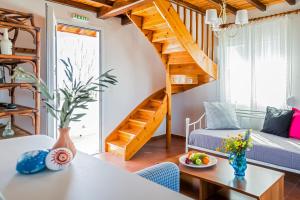 a living room with a spiral staircase in a house at Villa Thea in Panormos Skopelos