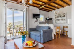 a living room with a couch and a table with fruit at Villa Thea in Panormos Skopelos