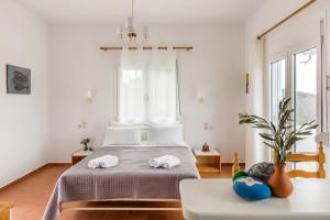 a bedroom with two towels on a bed at Villa Thea in Panormos Skopelos