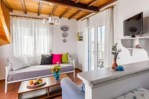 a living room with a couch and a table at Villa Thea in Panormos Skopelos