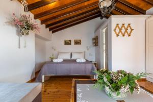 a bedroom with a bed and a table at Villa Thea in Panormos Skopelos
