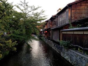 a river next to a building next to a building at Kyoto Inn Higashiyama in Kyoto