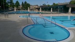 a large swimming pool with blue water at Central Apartments with Parking in Ljubljana