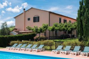a villa with a swimming pool in front of a house at La Torre Apartments in Pistoia