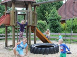 a group of children playing on a playground at Holiday Home in Germany with Terrace in Bredenborn
