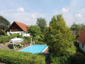a swimming pool in the yard of a house at Holiday Home in Germany with Garden Terrace in Bredenborn