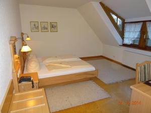 a small bedroom with a bed in a attic at WASSERSTELZ Historisches Genusshotel & Restaurant am Rhein in Hohentengen