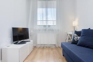 Televízia a/alebo spoločenská miestnosť v ubytovaní Elite Apartments Marine Suite