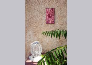 a sign on the side of a building with a bird statue at Contaratos Holiday Lettings 3 in Livadi