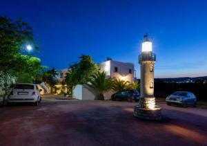 a light house sitting in a parking lot at night at Contaratos Holiday Lettings 3 in Livadi +14 photos