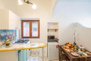 a kitchen with a sink and a counter top at Ricciolo d'oro 1 in Positano