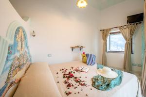 a bedroom with a bed with flowers on it at Ricciolo d'oro 1 in Positano +3 photos