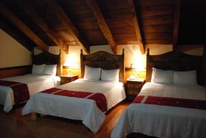 Säng eller sängar i ett rum på Hotel Temático Mision Colonial