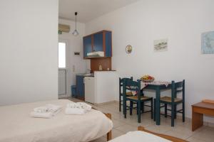 a kitchen with a table and chairs in a room at Contaratos Holiday Lettings 3 in Livadi