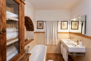 a bathroom with a white tub and a sink at Podere Il Lampo in Montalcino