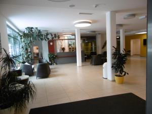 a lobby with potted plants in a building at Jugendherberge Tamsweg in Tamsweg