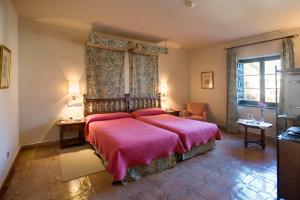 A bed or beds in a room at Parador de Jarandilla de la Vera