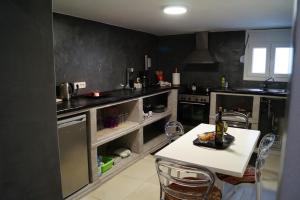 a kitchen with a table and chairs in it at Elysium Residence in Fira