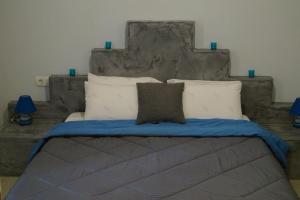 a bedroom with a large bed with a large headboard at Elysium Residence in Fira