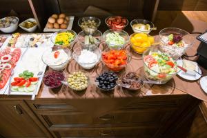 a table with many bowls of different types of food at Hotel Maksymilian in Krakow