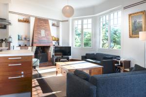 a living room with two couches and a fireplace at la Pinède in Dinard