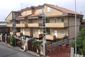 a building with a fence in front of it at EH Suites Rome Airport Euro House Hotels in Fiumicino