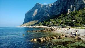 a group of people on a beach near the water at Casa Sferracavallo in Sferracavallo