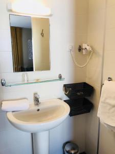 a bathroom with a sink and a mirror at l'auberge in Gamarde-les-Bains