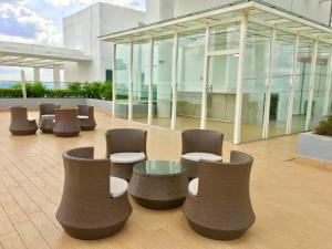 a lobby with chairs and tables and a building at Pinnacle Tower Apartment Stay by Feel Suites in Johor Bahru