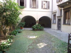 an empty courtyard of a building with two gates at La stufa rossa in Sondrio