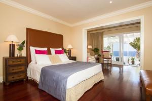 a bedroom with a large bed with pink pillows at Villa Mila in Puerto Calero +19 photos