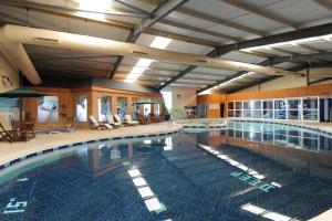 a large swimming pool in a large building at Croyde Bay Hotel or Self Catering in Croyde