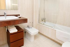 a bathroom with a sink and a toilet and a bath tub at 1215 - Ciutadella Pretty Apartment in Barcelona