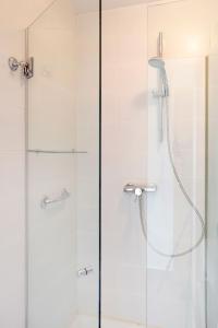 a bathroom with a shower with a glass door at 1217 - POOL AND BEACH NICE APARTMENT II in Barcelona