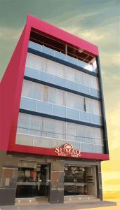 a building with a sunoco sign on the side of it at Sumaq Hotel Tacna in Tacna