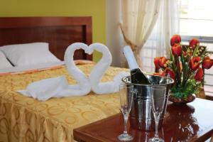 Postel nebo postele na pokoji v ubytování Sumaq Hotel Tacna