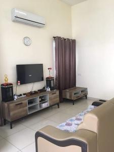 a living room with a flat screen tv and a couch at Kkp home stay in Alor Setar