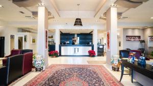 a lobby with chairs and a bar in a building at Plaza Hotel Catania in Catania