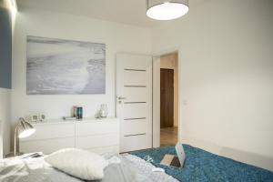 Łóżko lub łóżka w pokoju w obiekcie Apartamenty City View od WroclawApartament-pl
